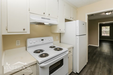a kitchen with white appliances and white cabinets